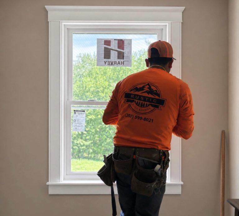 Rustic Build and Design team member in front of a window